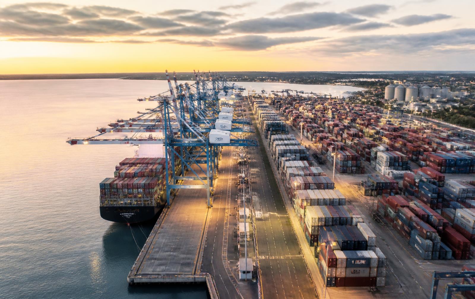 Container vessel discharging at Mombasa port with gantry cranes at dawn